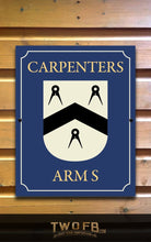 Load image into Gallery viewer, Sign with 'Carpenters Arms' and a crest on a wooden background
