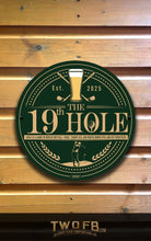 Load image into Gallery viewer, Circular sign with &#39;The 19th Hole&#39; design on a wooden background
