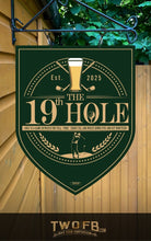 Load image into Gallery viewer, Decorative sign for &#39;The 19th Hole&#39; with golf-themed design on a green background.
