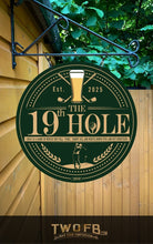 Load image into Gallery viewer, Decorative sign for &#39;The 19th Hole&#39; with golf-themed design on a wooden wall.
