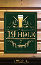 Load image into Gallery viewer, Decorative sign for &#39;The 19th Hole&#39; with golf-themed design on a wooden background.
