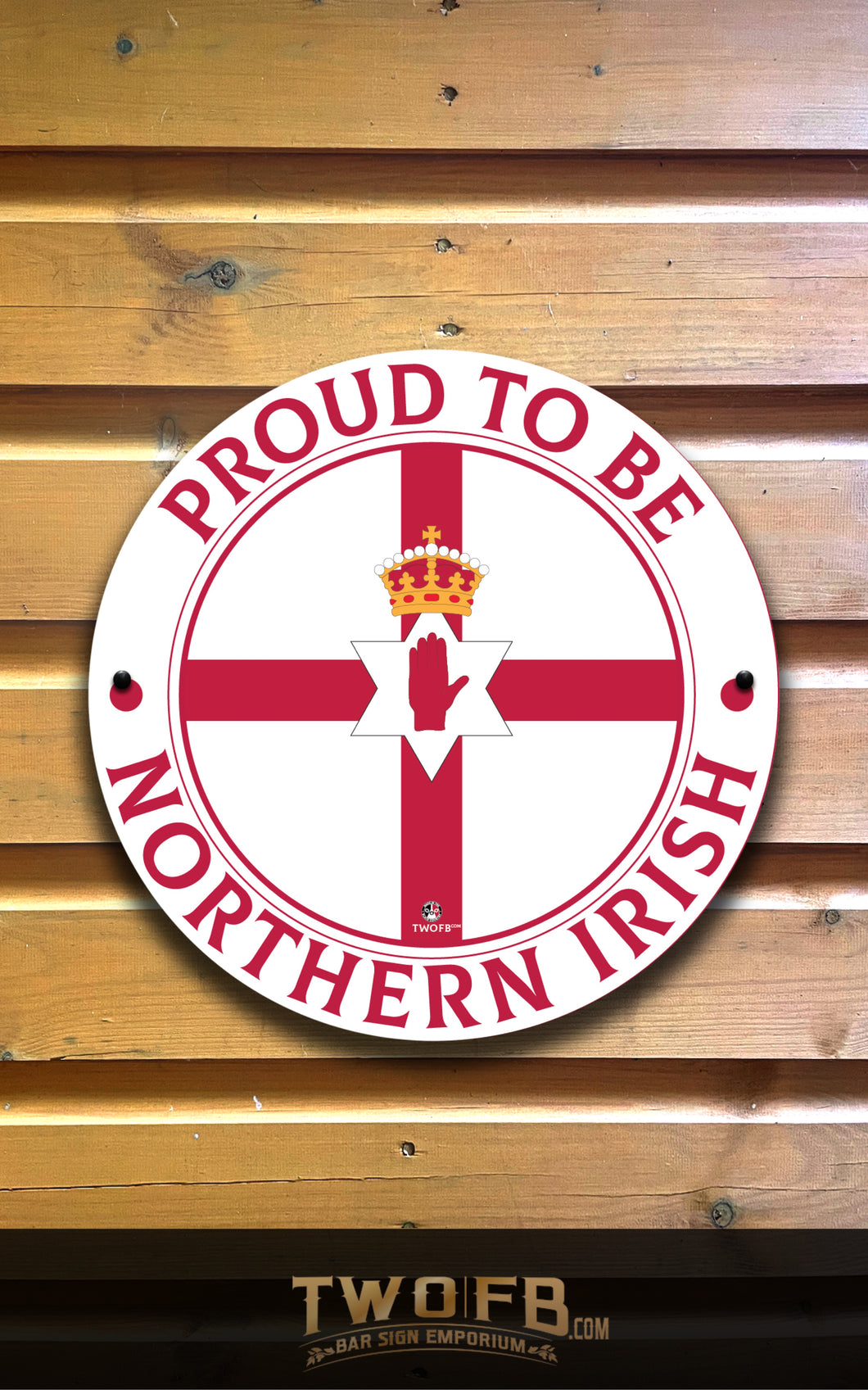 Circular sign with 'Proud to be Northern Irish' text on a wooden background