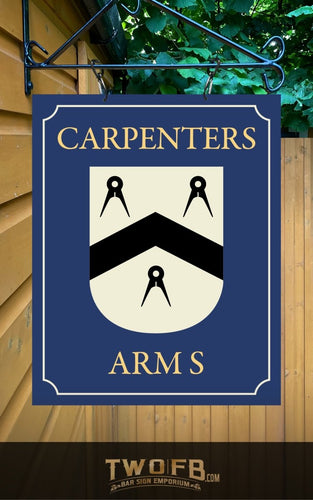 Decorative sign with 'Carpenters Arms' text and emblem on a blue background, hanging against a wooden wall.