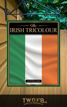 Load image into Gallery viewer, Irish Tricolour flag sign hanging on a wall with greenery in the background
