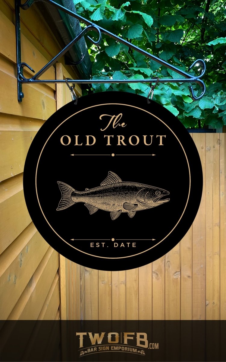 Round sign with 'The Old Trout' and fish illustration on a wooden wall.