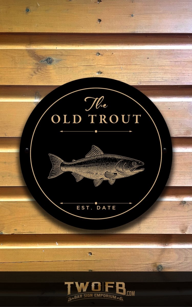 Round sign with 'The Old Trout' and a fish illustration on a wooden background