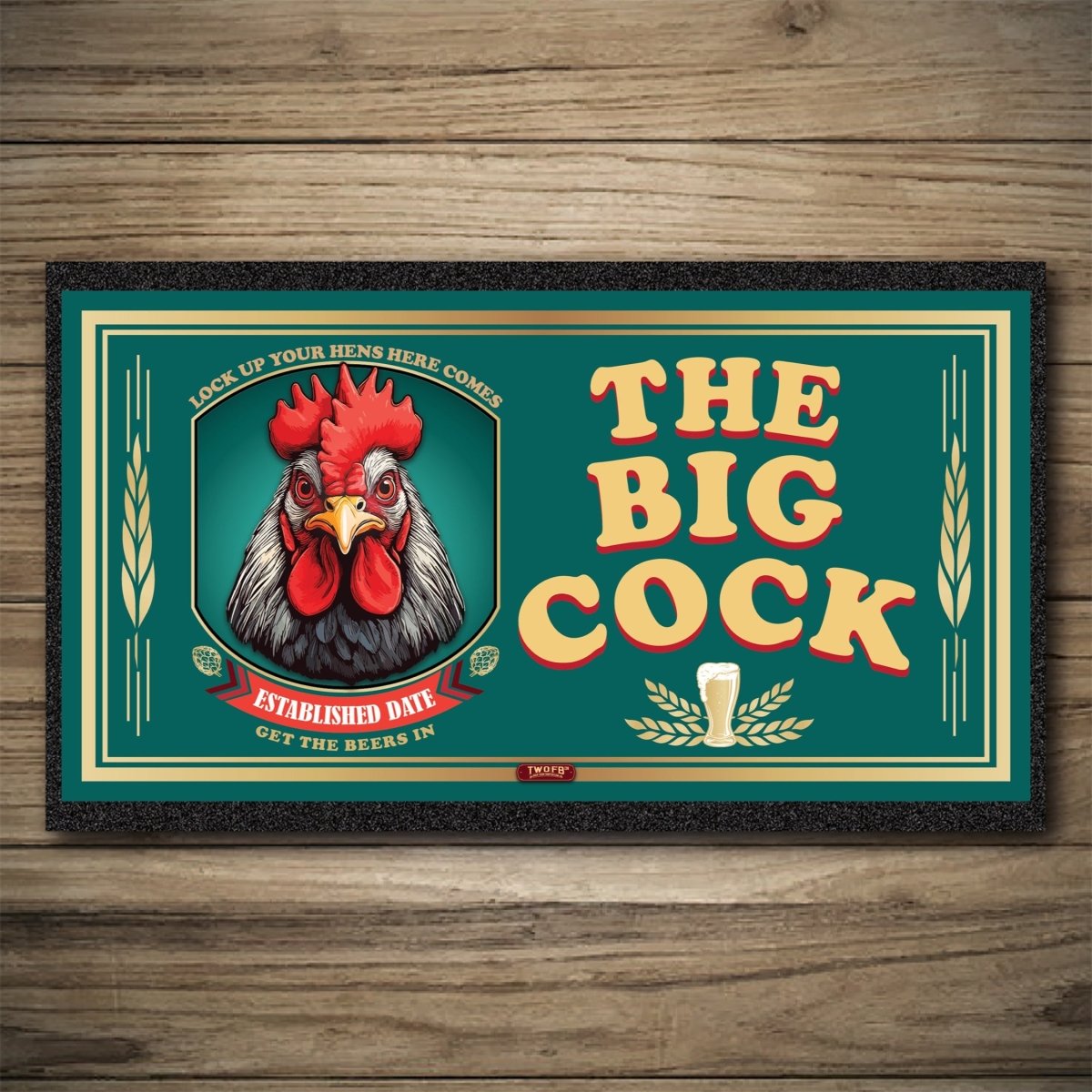 Decorative mat with a rooster illustration and text 'The Big Cock' on a wooden background