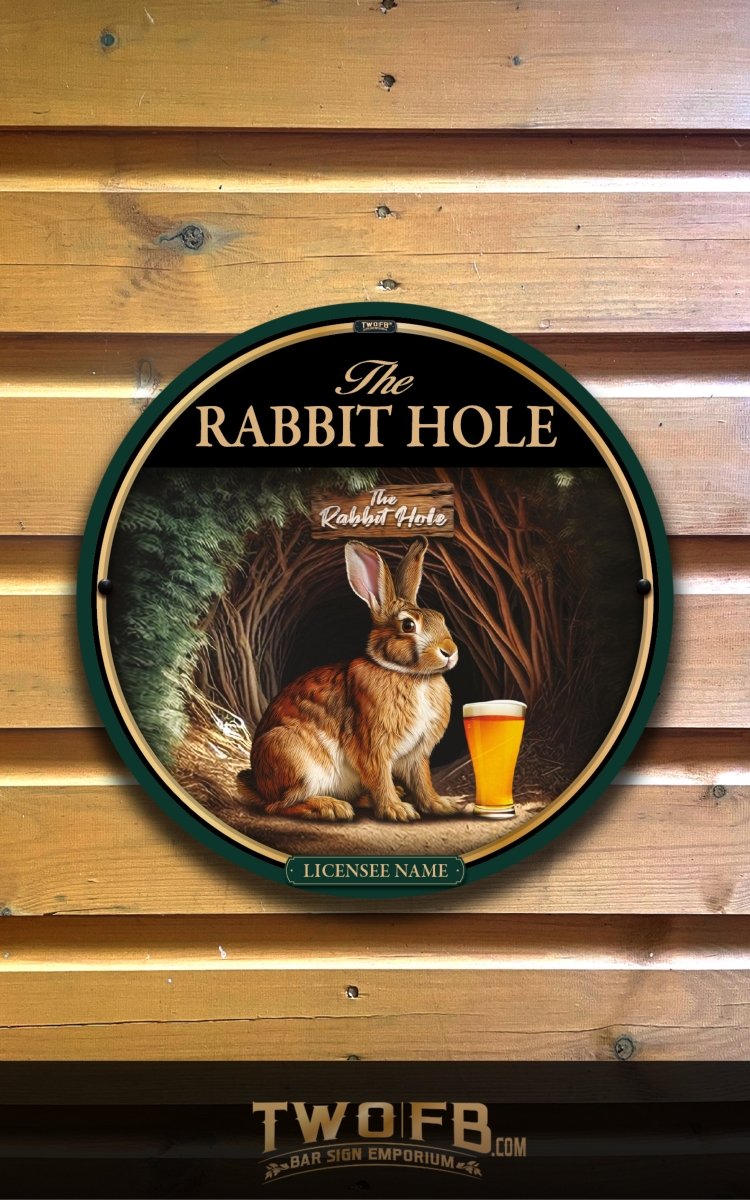 Round sign with a rabbit and beer on a wooden background, featuring 'The Rabbit Hole' and 'TWO.FB'.
