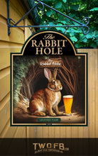 Load image into Gallery viewer, Decorative sign for &#39;The Rabbit Hole&#39; with a rabbit holding a beer mug, hanging outside a building.
