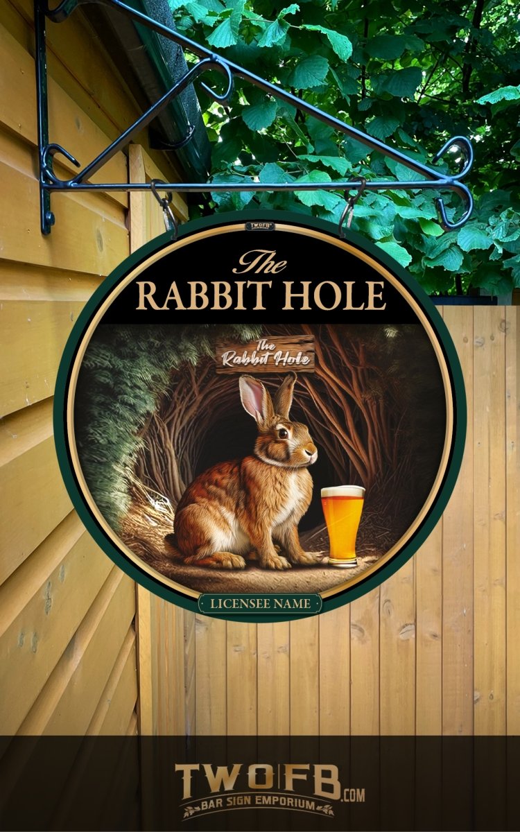 Round sign with a rabbit and beer glass, featuring 'The Rabbit Hole', on a wooden background.
