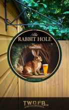 Load image into Gallery viewer, Round sign with a rabbit and beer glass, featuring &#39;The Rabbit Hole&#39;, on a wooden background.
