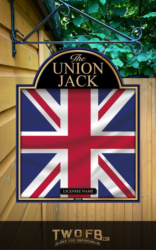 Union Jack sign hanging on a wall with greenery in the background