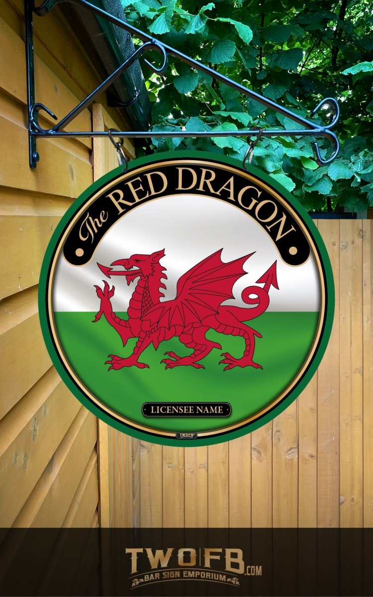 Round sign with red dragon emblem on a white and green background, hanging on a wooden building.
