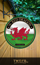 Load image into Gallery viewer, Round sign with red dragon emblem on a white and green background, hanging on a wooden building.

